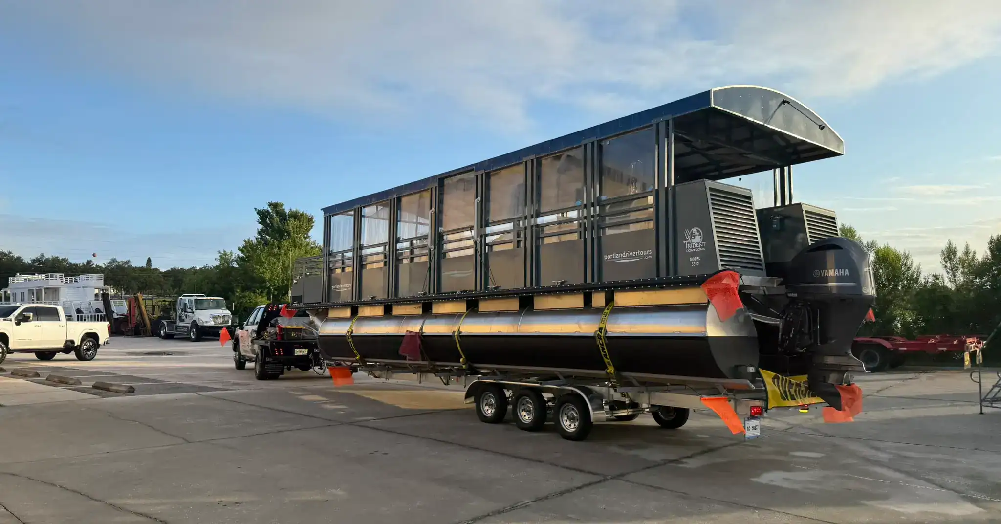 Trident Pontoons Portland River Tours custom boat on trailer with twin Yamaha engines prepared for delivery