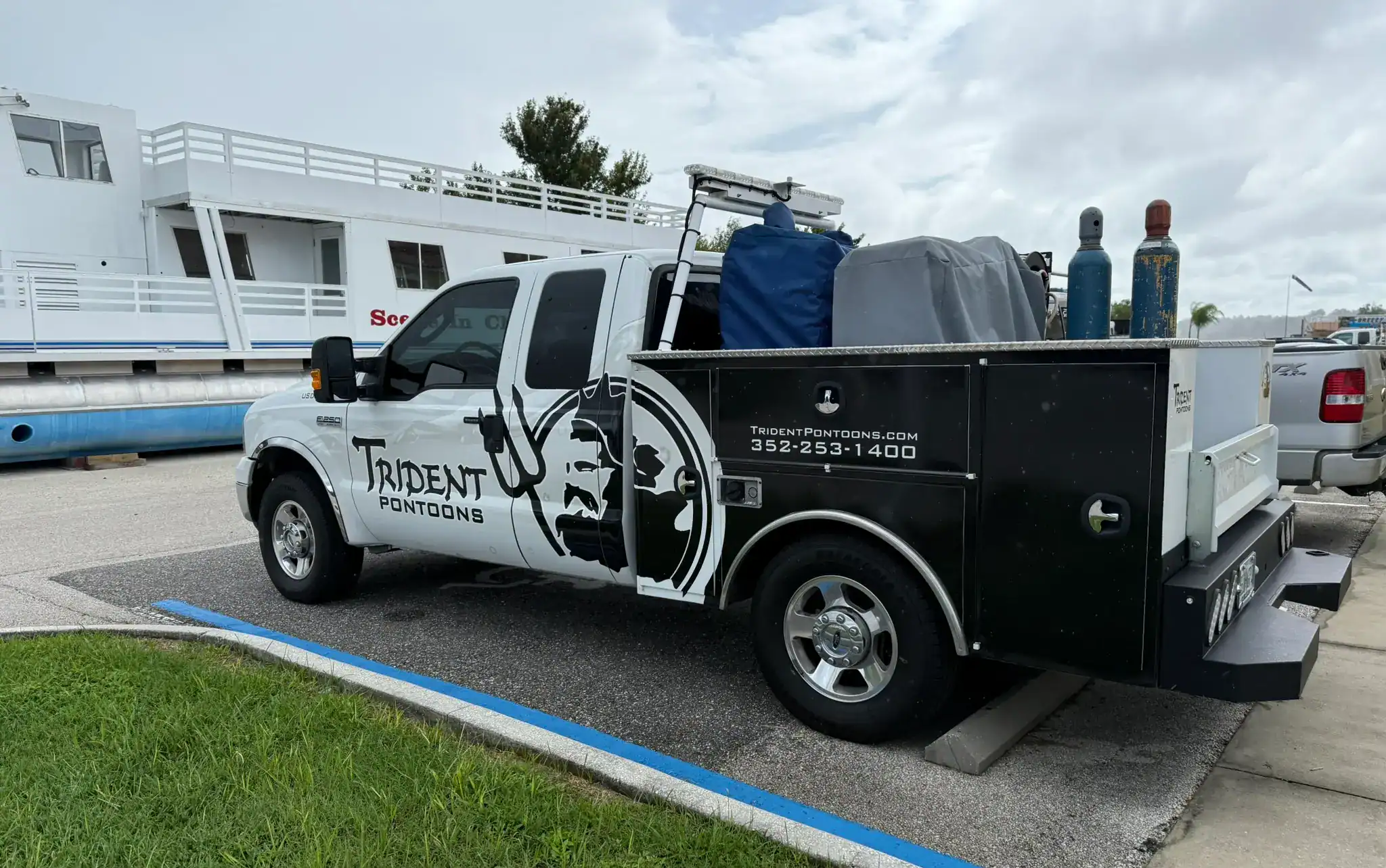 Trident Pontoons service truck dockside supporting maintenance and delivery operations